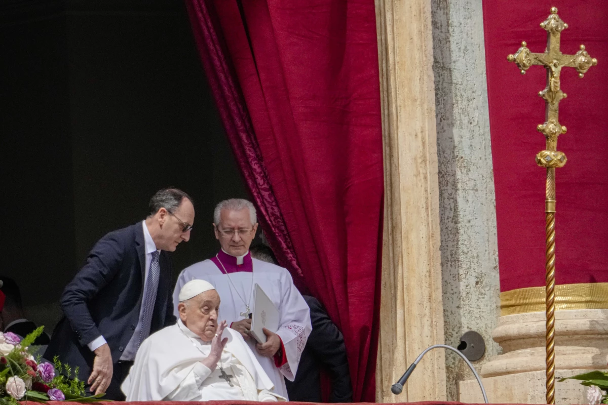Pope Francis appears on the central lodge of St. Peter's Basilica to bestow the Urbi et Orbi (Latin for to the city and the world) blessing at the end of the Easter mass presided over by Cardinal Angelo Comastri in St. Peter's Square at the Vatican Sunday, April 20, 2025.
