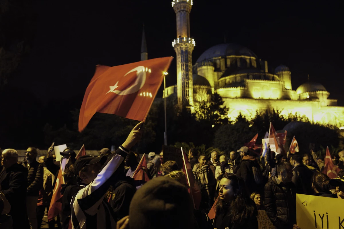 Protesters wave Turkish flags in front of the New Mosque in Istanbul. Despite a government protest ban, mass demonstrations erupted nationwide following the arrest of Istanbul Mayor Ekrem Imamoglu on corruption charges, with crowds demanding democracy and chanting 'people, rights, justice.' Scholars of democracy view Turkey as a competitive authoritarian regime in which the ruling party uses institutions such as the courts to attack their political opponents.