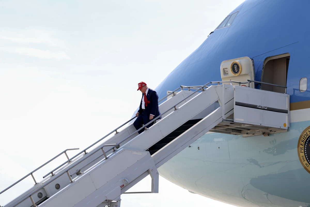 President Trump walks off Air Force One on April 29 at Selfridge Air National Guard Base, Michigan. Qatar has offered to replace Air Force One with a luxury Boeing 747 jet.