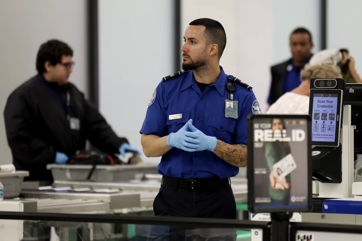 A Transportation Security Administration agent stands at a security checkpoint at Miami International Airport on Dec. 20, 2024. The federal government is preparing to begin implementing Real ID rules in May.