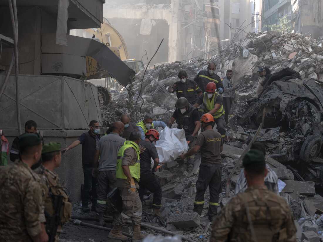 Civil defense members carry out a body from the site of an Israeli strike in Beirut's Basta neighbourhood, amid the ongoing hostilities between Hezbollah and Israeli forces, Lebanon. November 23, 2024.
