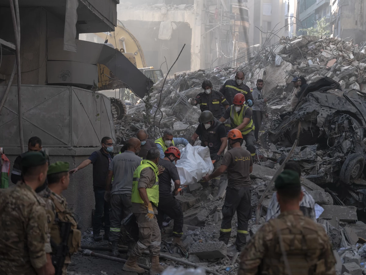 Search-and-rescue teams carry a body recovered from the rubble at the site of an Israeli strike on a central Beirut neighborhood in Lebanon on Nov. 23. Click here for the full story. 