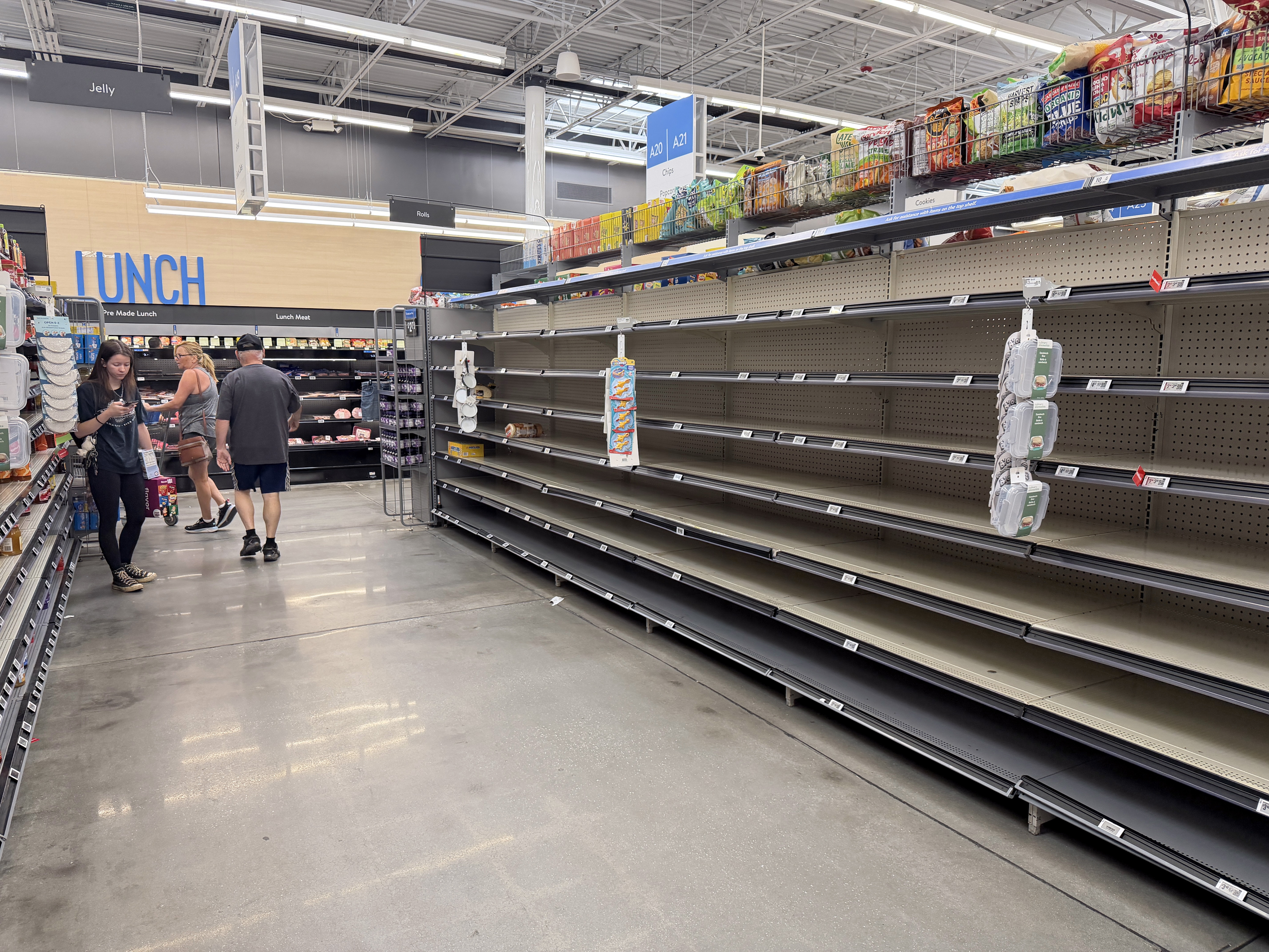 Shelves were empty of bread in a Walmart store in Gulf Breeze, Fla., on Thursday, as people stocked up ahead of the arrival of Hurricane Isaias.