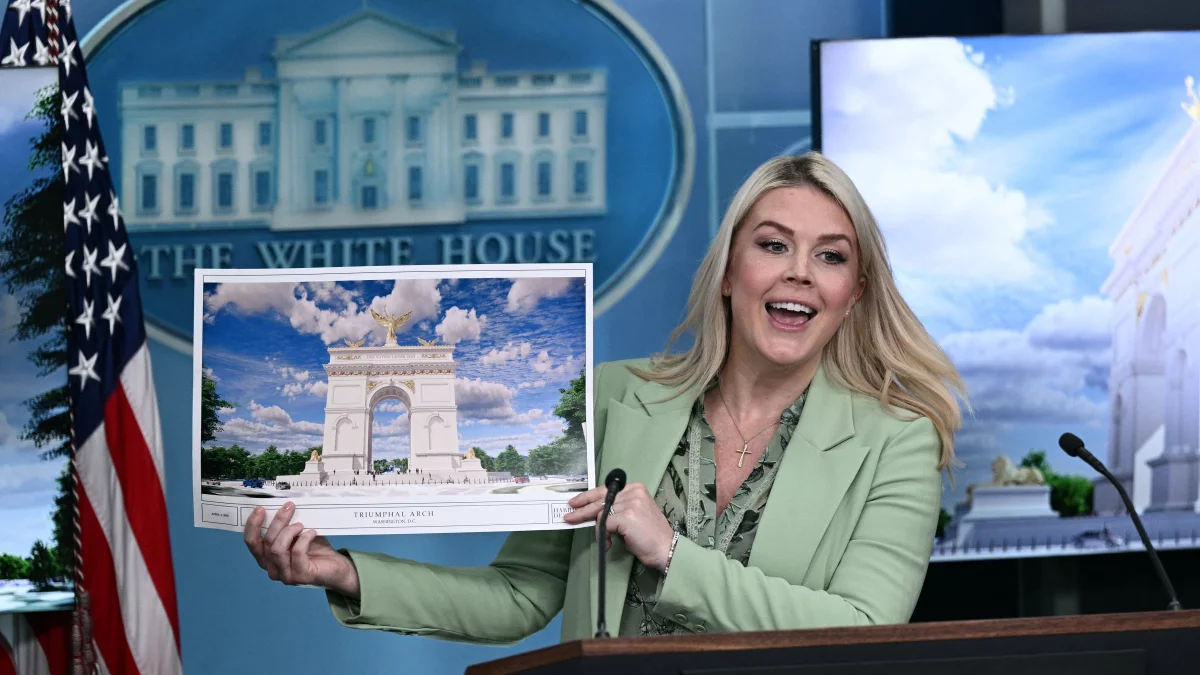 White House press secretary Karoline Leavitt shows a rendering of the planned triumphal arch to be added to Washington, D.C.'s National Mall at a meeting on Wednesday.