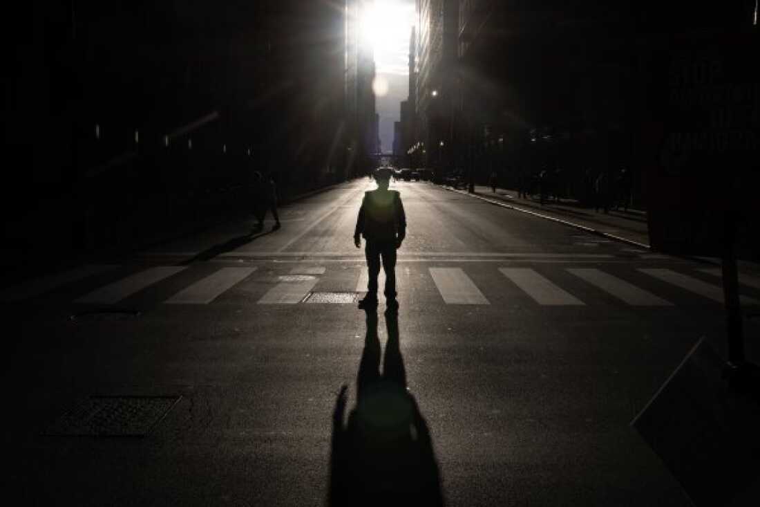 A police officer stands guard as demonstrators march through downtown during a protest against President Trump's immigration policies on Sept. 6 in Chicago, Ill. 