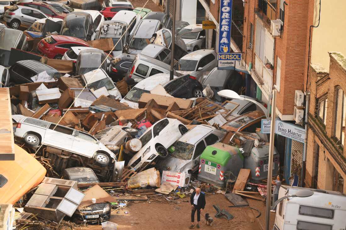 Cars are piled in the street with other debris in Valencia, Spain, after flash floods in October. Scientists with a group called World Weather Attribution said the flooding was caused by intense rainfall that was 12% heavier and twice as likely due to climate change.