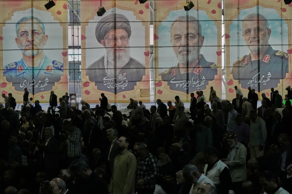 Iranian worshippers perform their Friday prayers under the portraits of the late Iranian Supreme Leader Ayatollah Ali Khamenei (second left) and top military officials who were killed during the U.S.-Israel campaign, at the Tehran University campus, in Tehran, Iran, on April 24. (AP)