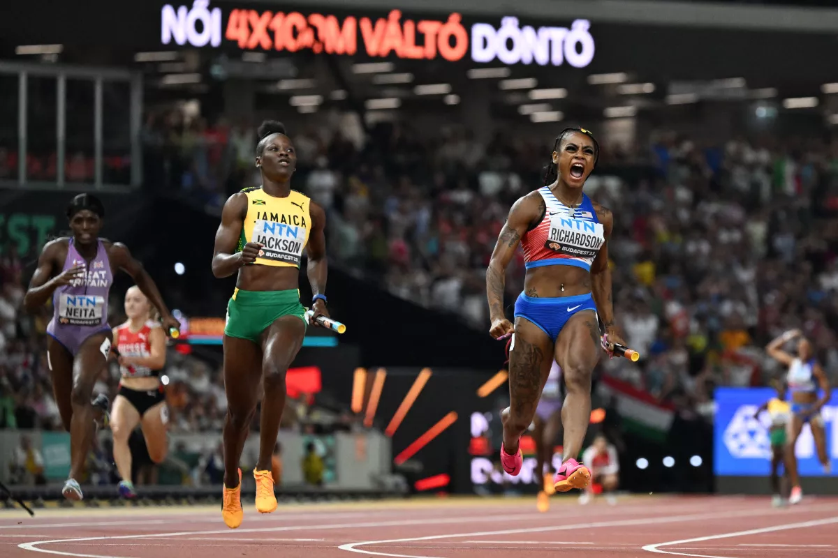 USA's Sha'Carri Richardson reacts as she approaches the finish line with Jamaica's Shericka Jackson in the women's 4x100m relay final during the World Athletics Championships at the National Athletics Centre in Budapest on Aug. 26, 2023.
