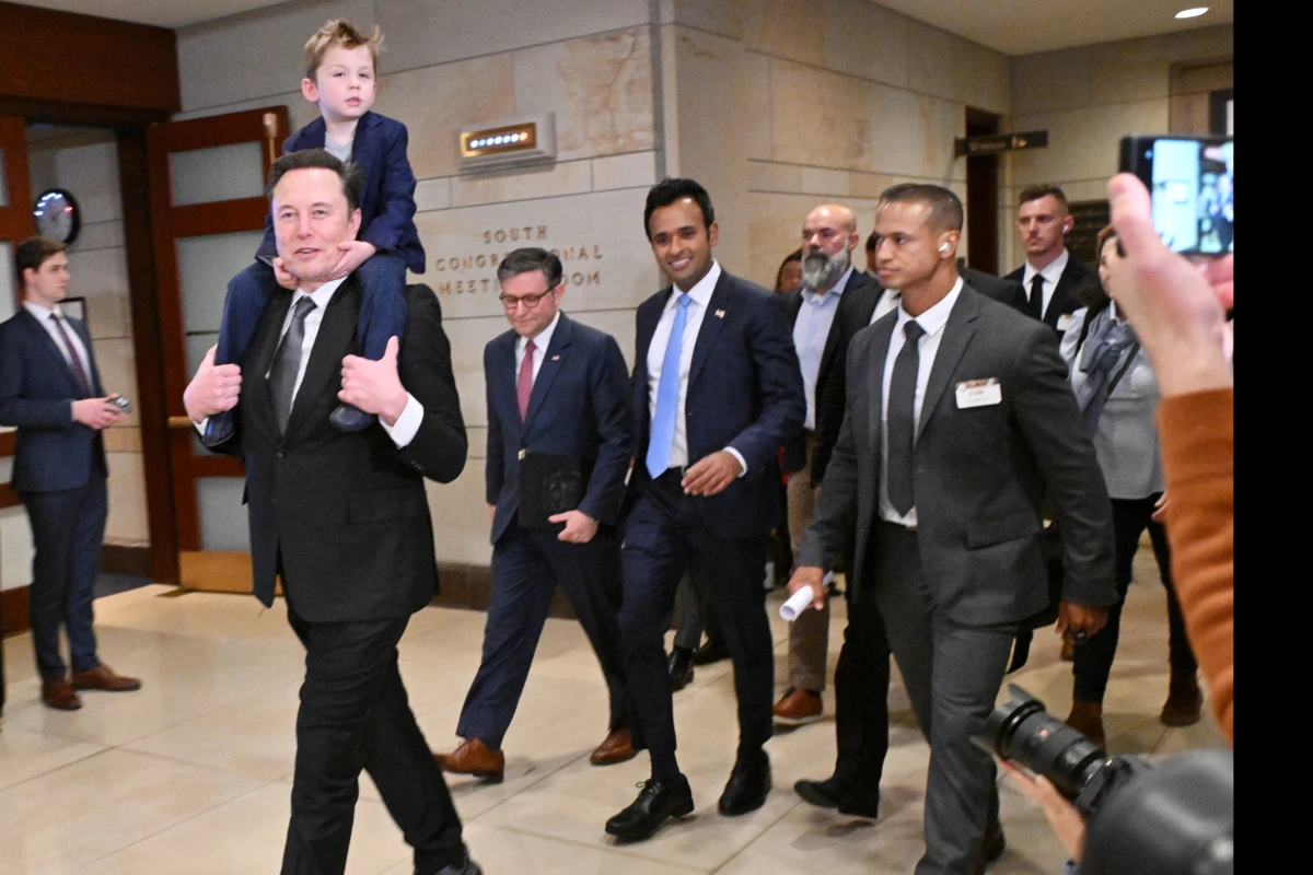 Tesla CEO Elon Musk (left), co-chair of the newly created Department of Government Efficiency (DOGE), carries his son 'X' on his shoulders, as he walks with Speaker of the House Mike Johnson (second from left) and DOGE co-leader, businessman Vivek Ramaswamy (center), before a meeting with members of Congress at the Capitol on Dec 5.