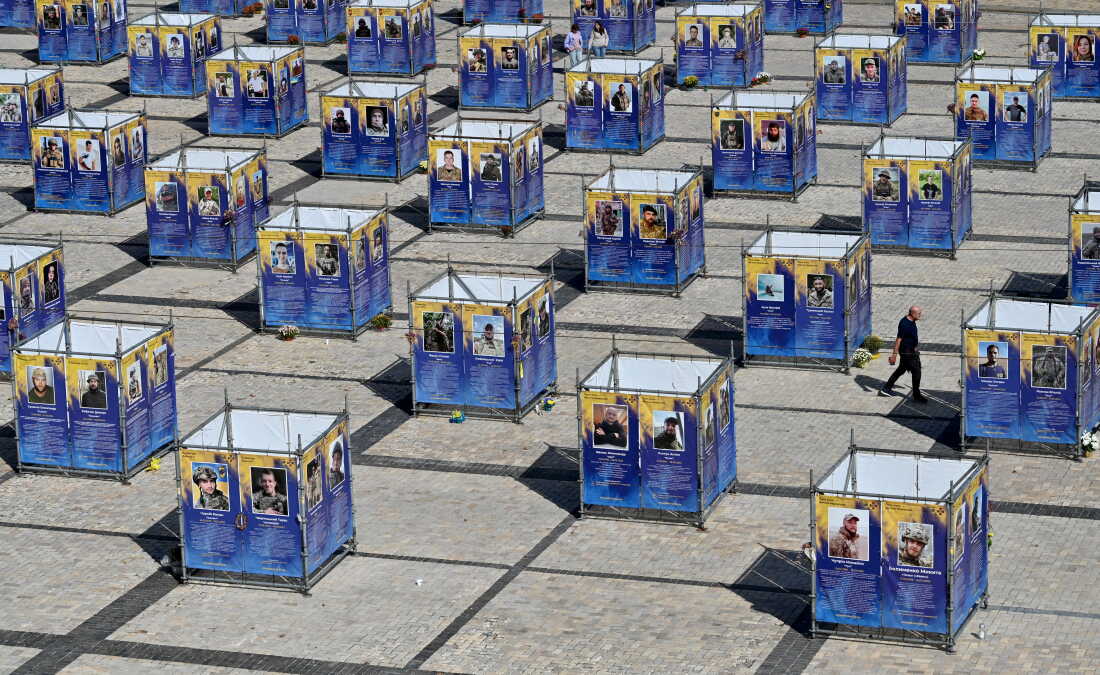 A man walks between stands displaying portraits of fallen Ukrainian fighters, which have been set up at St Sophia Square in the center of Kyiv on Sept.15, 2026, amid the Russian invasion of Ukraine.