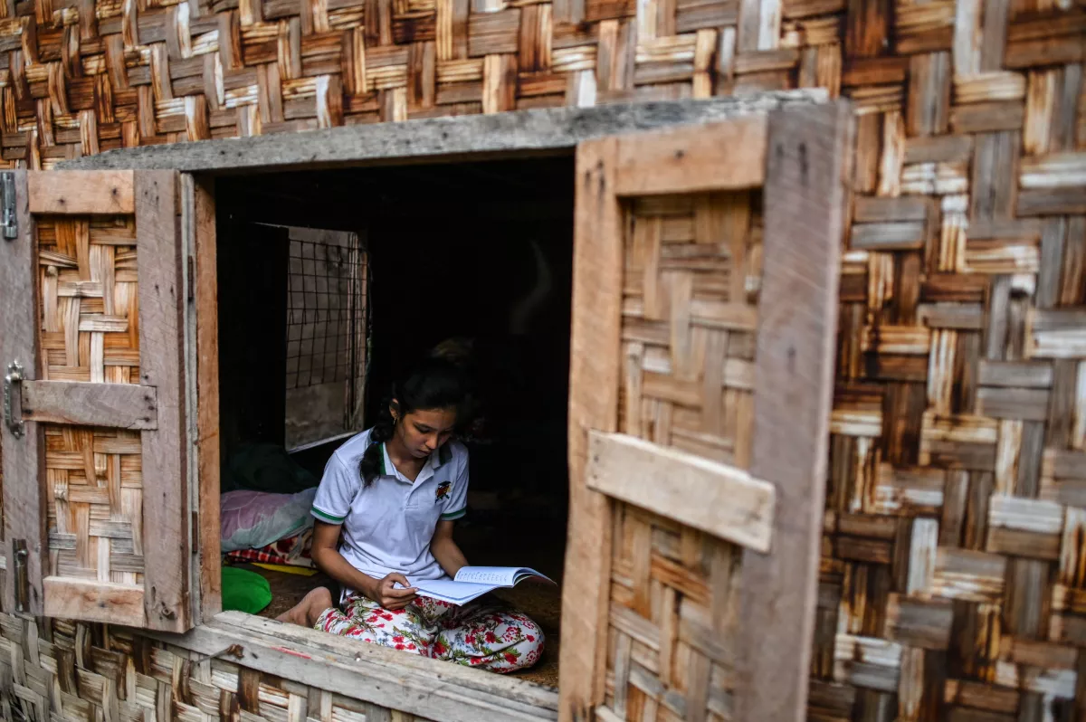 This photo taken on June 20, 2020 shows 18-year-old Muslim May Thandar Maung, who says she hasn't been able to get an ID card because of her religion and hence unable to vote in the upcoming election, studying Arabic and religion in her home in Meiktila, Mandalay Region.