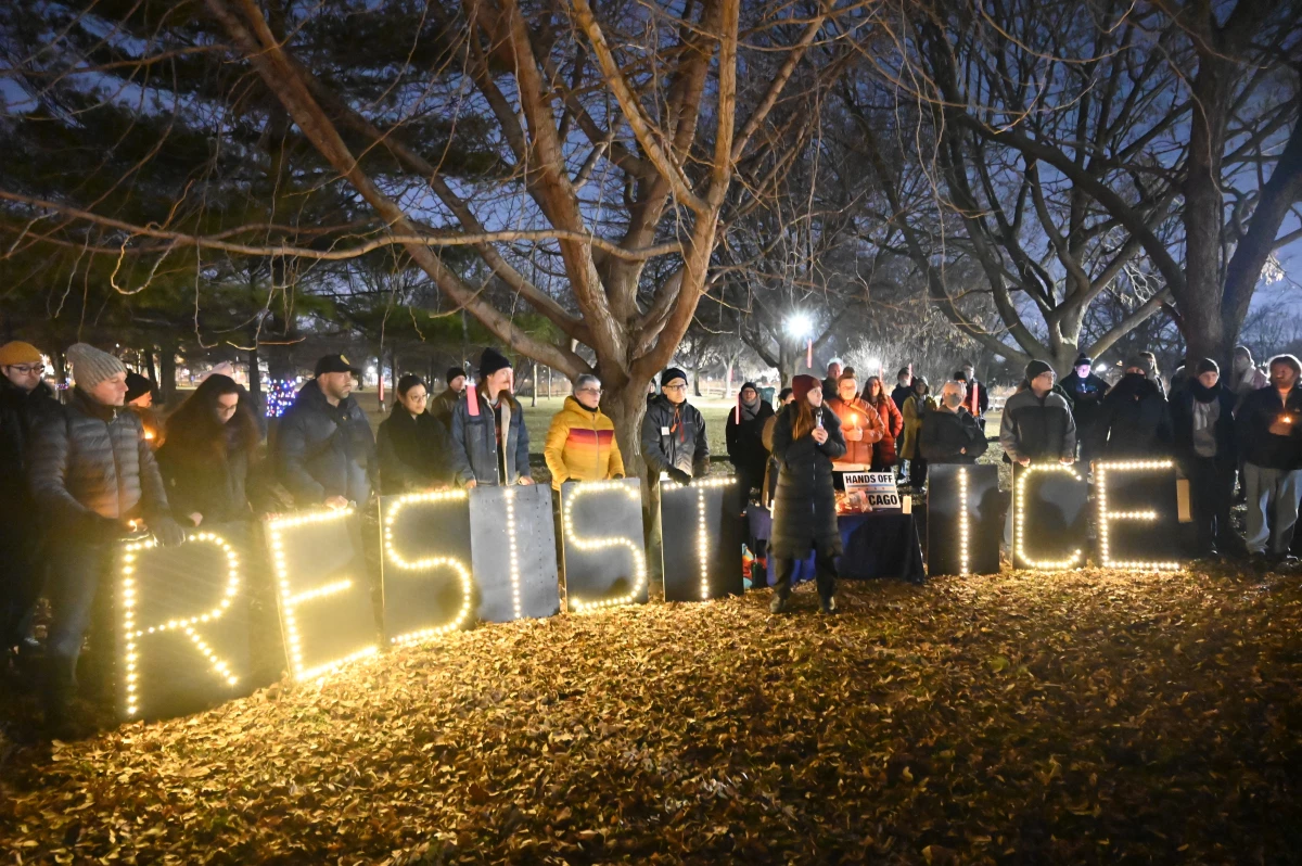 Demonstrators hold a vigil organized by the Ward 40+ Community Response Team at Winnemac Park in Chicago, Ill., on Wednesday.