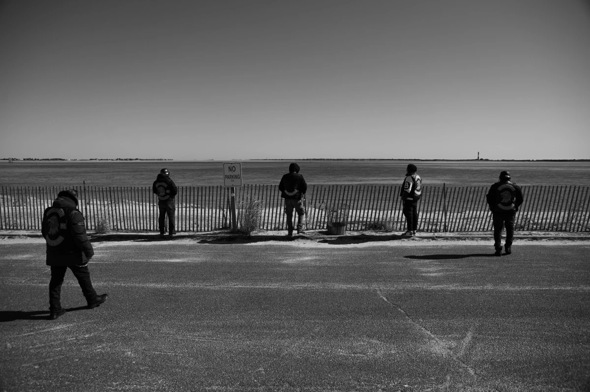 Some of the Aztec Rebels look out toward a lake in Long Island during a ride.