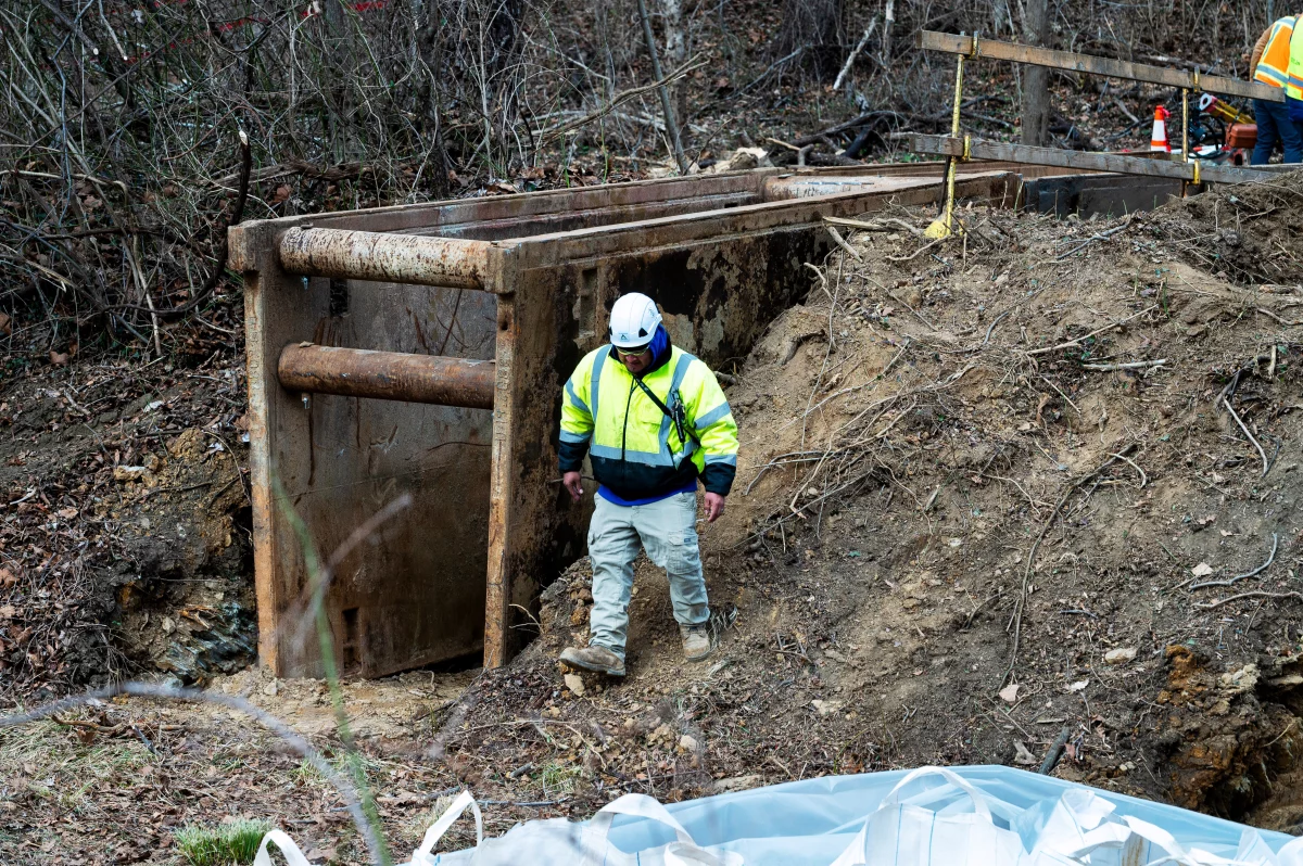A worker walks past part of a cofferdam being built to stop the flow of raw sewage into the Potomac River after a massive sewage pipe rupture in Maryland in January.