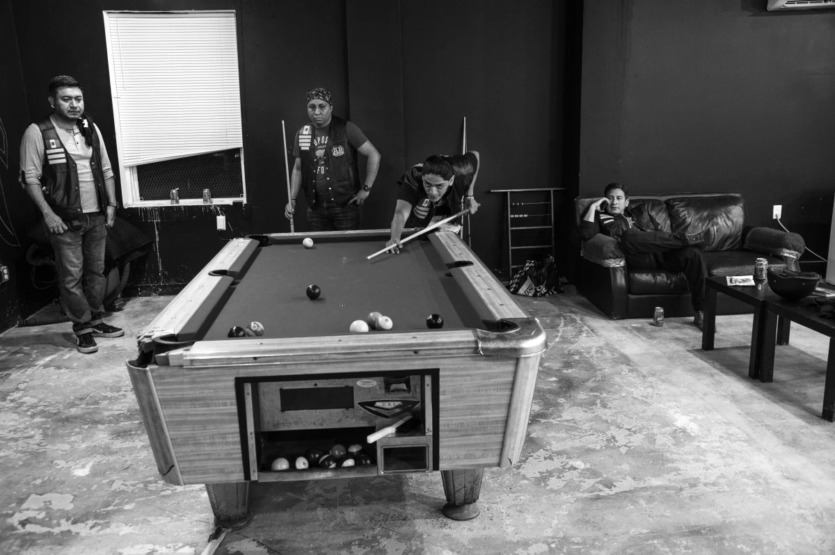 Members of the Aztec Rebels play pool in their newly opened clubhouse.