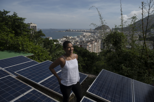 Woman in Brazilian favela with solar panels