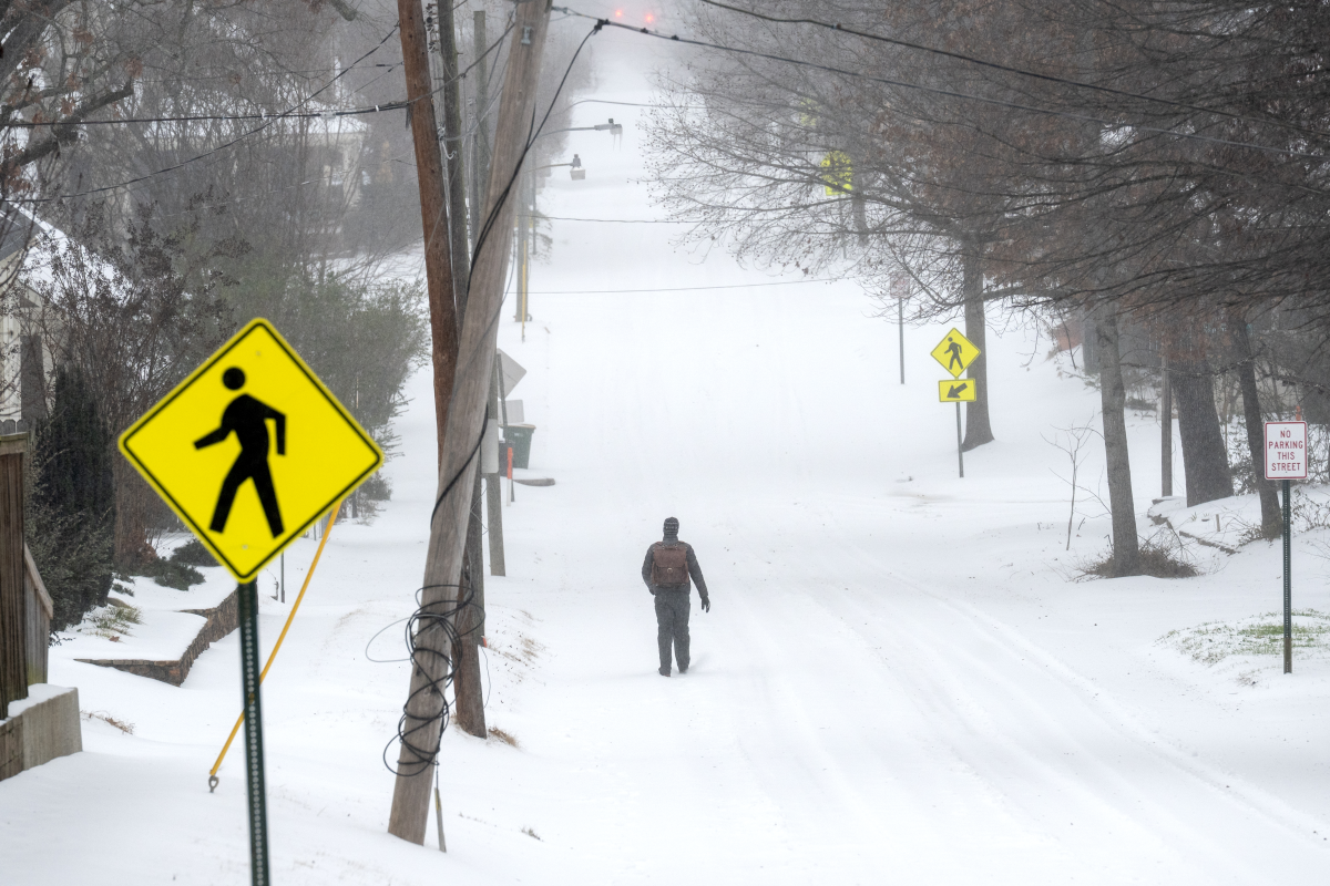A person walks in the snow in Little Rock, Arkansas. A massive winter storm is bringing frigid temperatures, ice, and snow to nearly 200 million Americans.