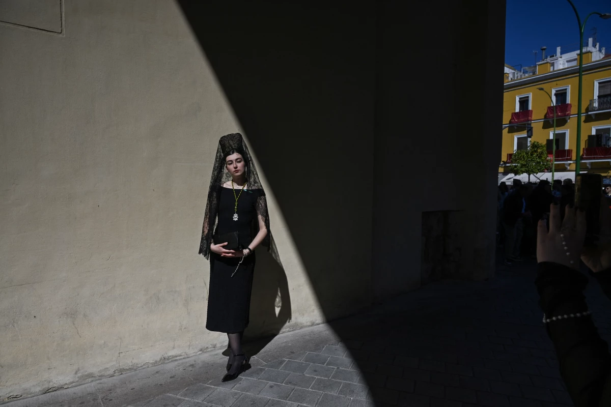 A woman wearing a traditional shawl known as a mantilla stands outside the Basilica de la Macarena church during Holy Week in Seville, Spain, on Thursday.