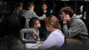 Kellen Hedler’s classroom aid, Parker Van Buskirk, checks in with Kellen as he works on an assignment. Kellen is largely independent throughout the school day, but Van Buskirk is available in case he needs help.