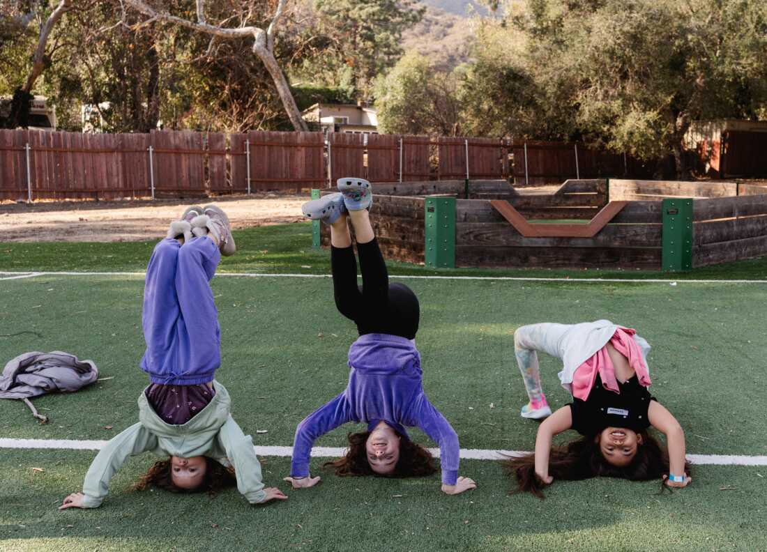 Campers do handstands on the soccer field at Camp Bob Waldorf in Glendale, Calif.
