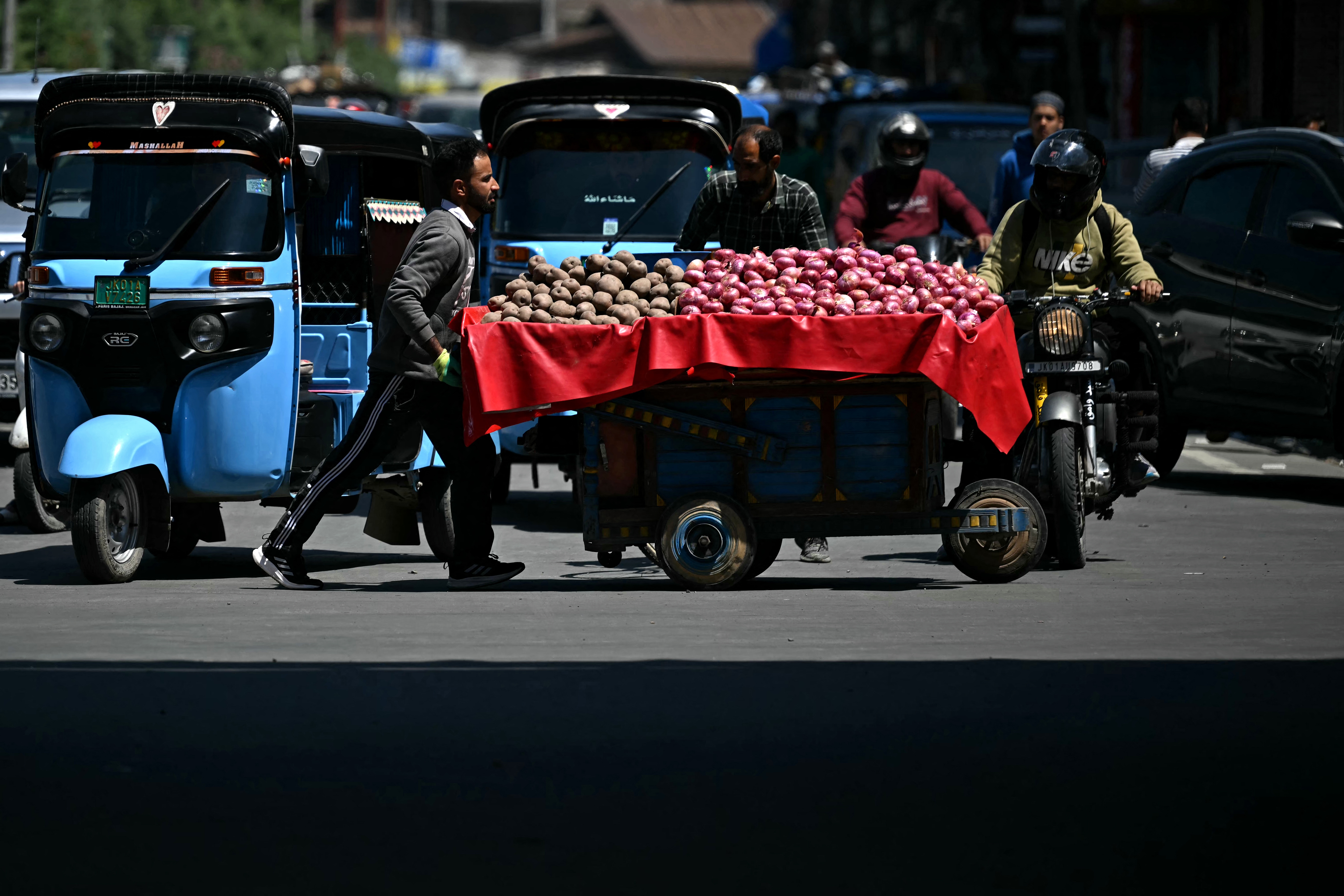 A vendor pushes his cart across a road in Srinagar on Monday. The frontier between India and Pakistan had the "first calm night in recent days," the Indian army said on May 12, after a weekend ceasefire.