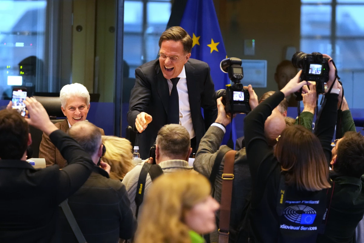 NATO Secretary General Mark Rutte, center, greets the audience prior to his address during the Security and Defence Committee at the European Parliament in Brussels, Monday, Jan. 26, 2026.