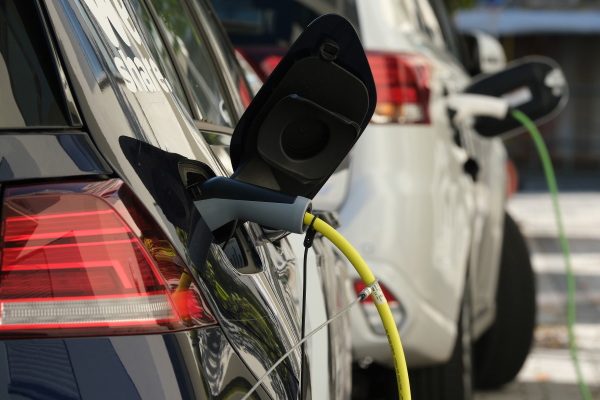 An electric car and a plug-in hybrid car charge at a public charging station on October 12, 2019 in Berlin, Germany.