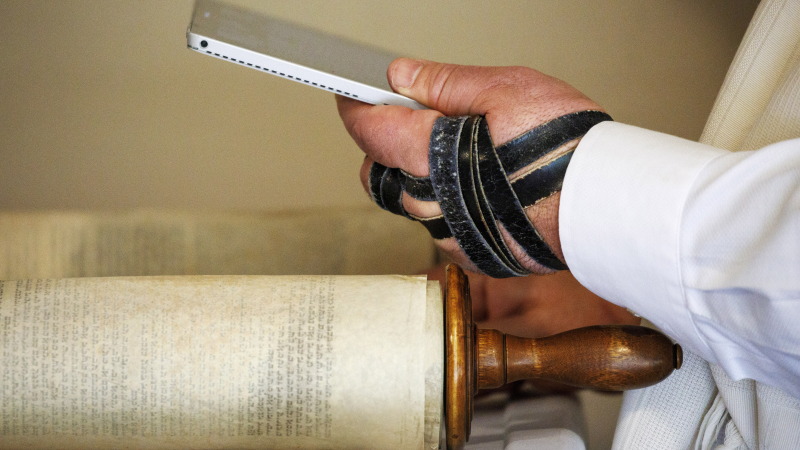 Rabbi Haim Ovadia reads the Torah to 32 people attending a Zoom meeting of a virtual minyan from his Maryland home in 2020.