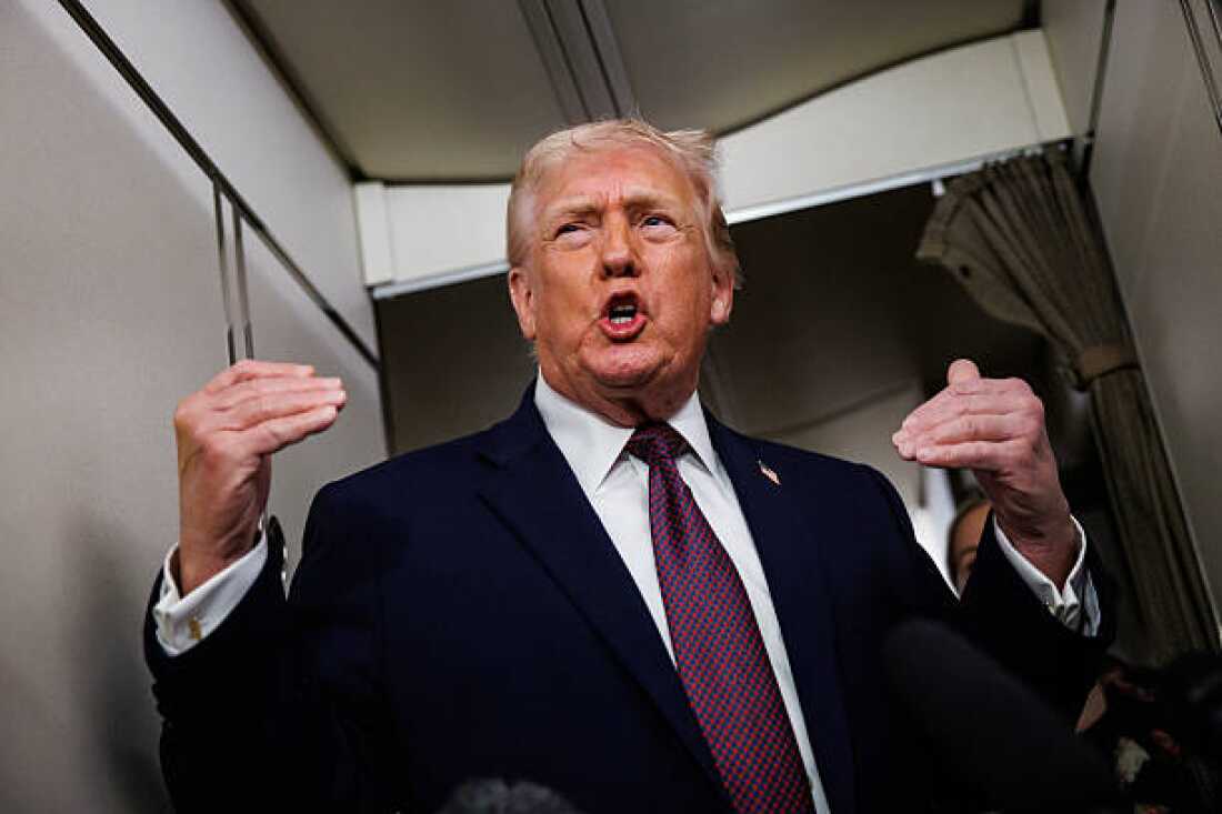 President Donald Trump takes questions from the members of the press aboard Air Force One.