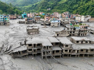 An aerial view shows houses lying deluged in sludge after flash floods at Devighat, Bidur Municipality in Nepal's Nuwakot district on August 27, 2026.