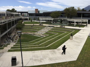 People walk near the site where conservative commentator Charlie Kirk was killed on the campus of Utah Valley University in Orem, Utah on Aug. 28, 2026.