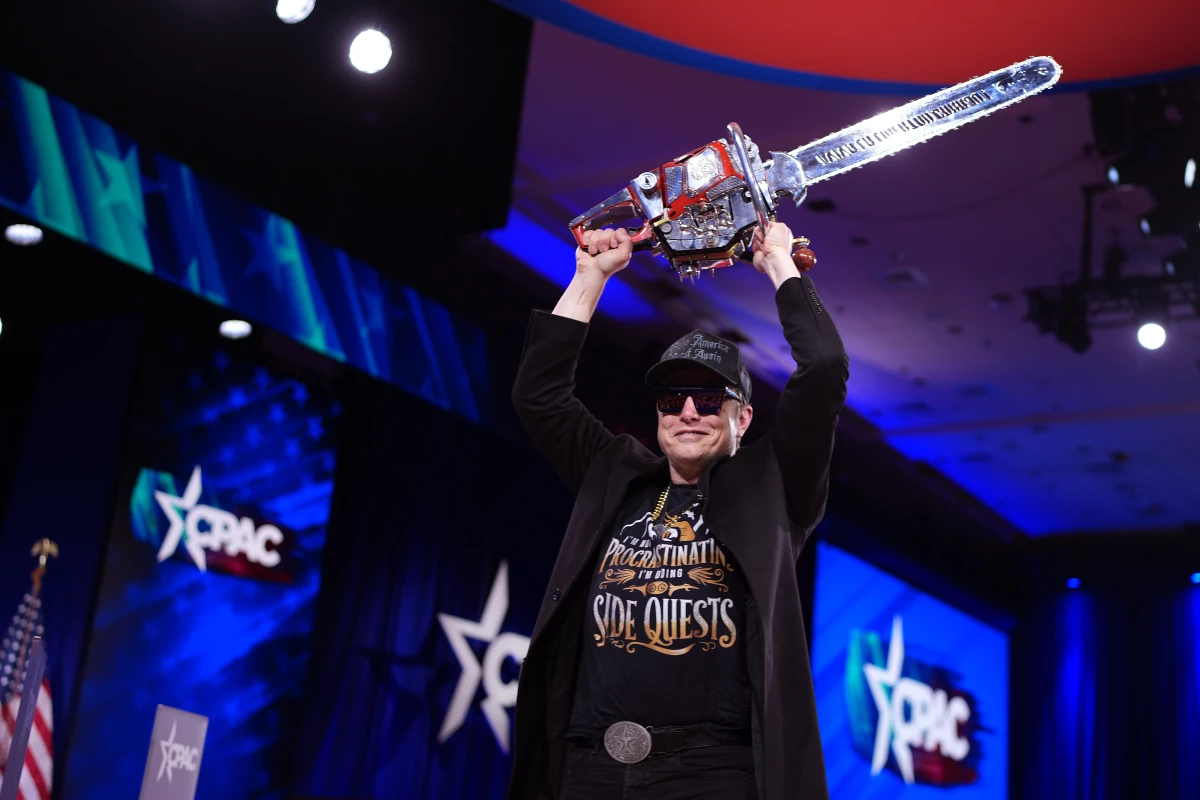 CEO of Tesla and SpaceX Elon Musk, head of the Trump administration's team tasked with slashing the size of the federal government, leaves the stage holding a chainsaw after speaking at the Conservative Political Action Conference (CPAC) on Feb. 20 in Oxon Hill, Md.