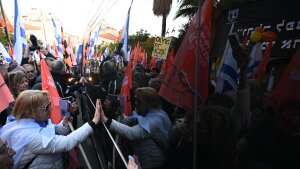People line the street to watch the funeral procession carrying the caskets of Shiri Bibas, Kfir Bibas and Ariel Bibas with family in minibuses pass by on Feb. 26, 2025 in Rishon LeZion, Israel.