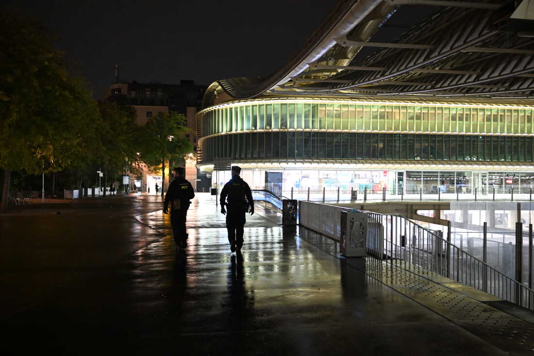 Policemen patrol during an overnight curfew in Paris, Tuesday, Oct. 20, 2026.
