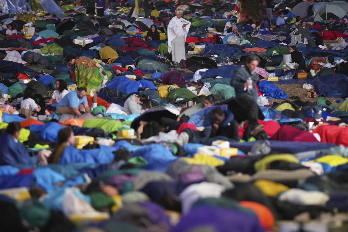 Young people wake up after spending the night at the Tor Vergata field in Rome as they participate in the Youths Jubilee, Sunday, Aug. 3, 2025.