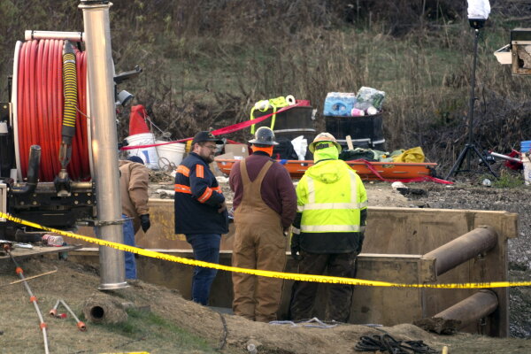 Rescue workers continue to search on Wednesday for Elizabeth Pollard, who is believed to have disappeared in a sinkhole while looking for her cat, in Marguerite, Pa.