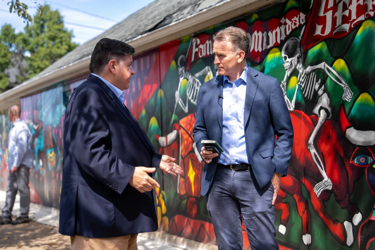 Gov. Pritzker talks with NPR's Steve Inskeep in Pilsen, a Chicago neighborhood known for colorful murals that pay homage to its Hispanic roots.