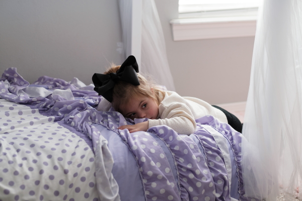 Adaline Whitmer takes a break from playing with her favorite person: her grandfather Sam Hester. He says she’ll often take her iPad into her parents’ closet and watch videos to teach herself to talk. “She’s aware of some of her limitations and tries to work through them.”