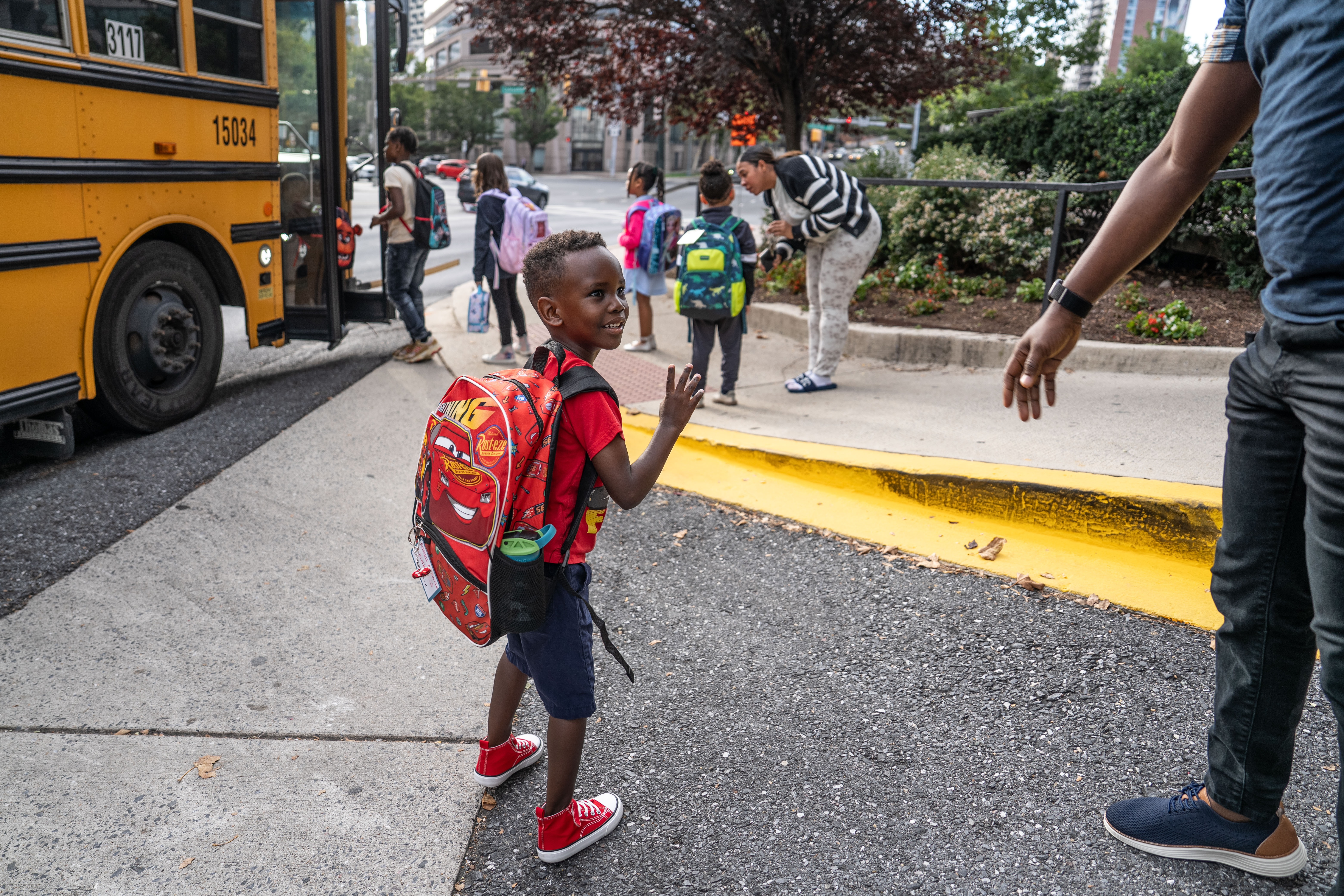 Russell Siima, who started his first year of kindergarten at a public school in Montgomery County, Md., this week, waves goodbye to his parents. The milestone gave his dad a flashback to his own start of school in Uganda.