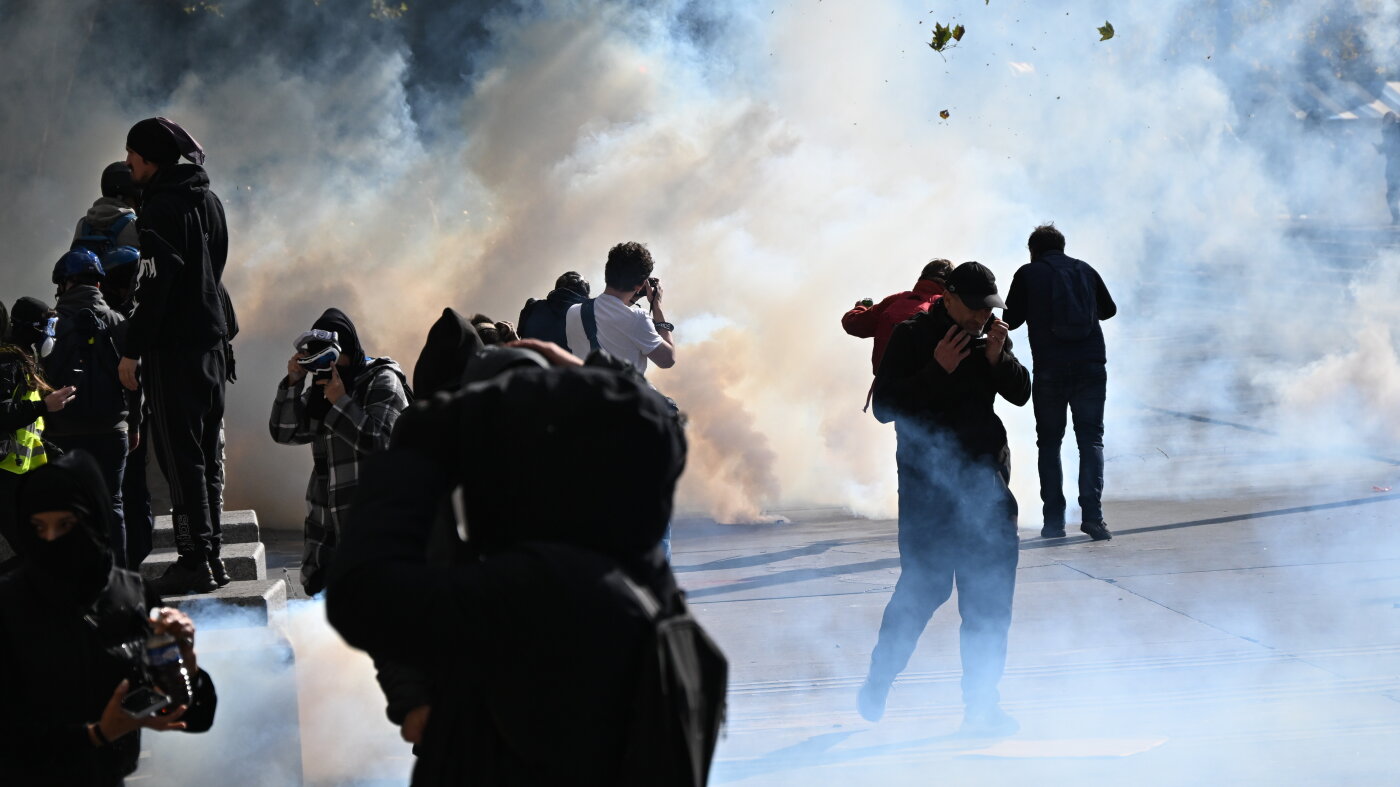 Scuffles and fires break out as protesters rally across France, joining students