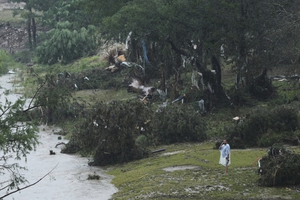 A man surveys damage left by a raging Guadalupe River n Kerrville, Texas. 