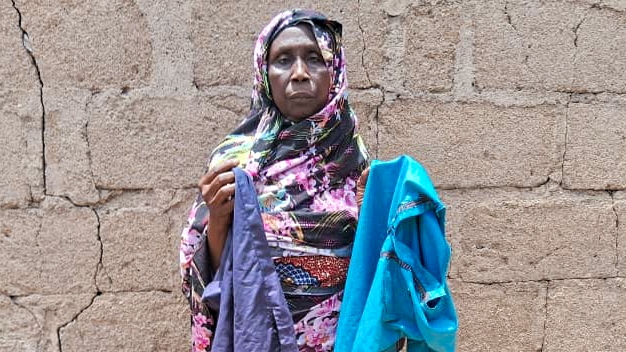 Mariam Mohammed, a widow, stands outside her home in Bama, Nigeria. She