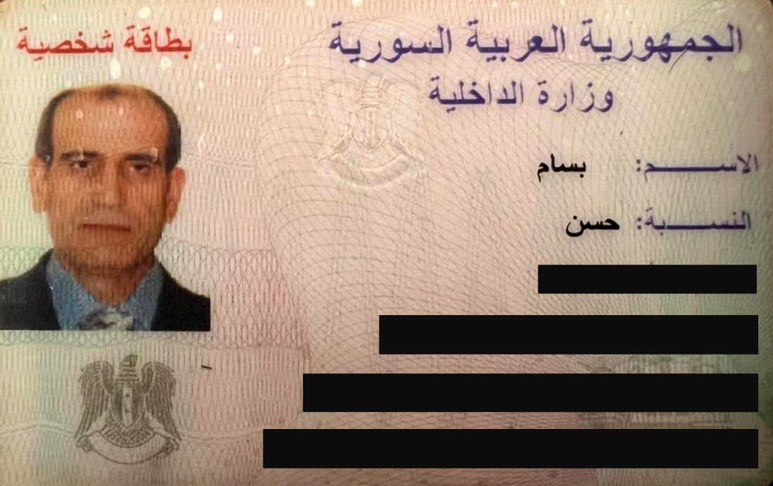 A scan of Bassam al-Hassan's Syrian ID that has been partially redacted.