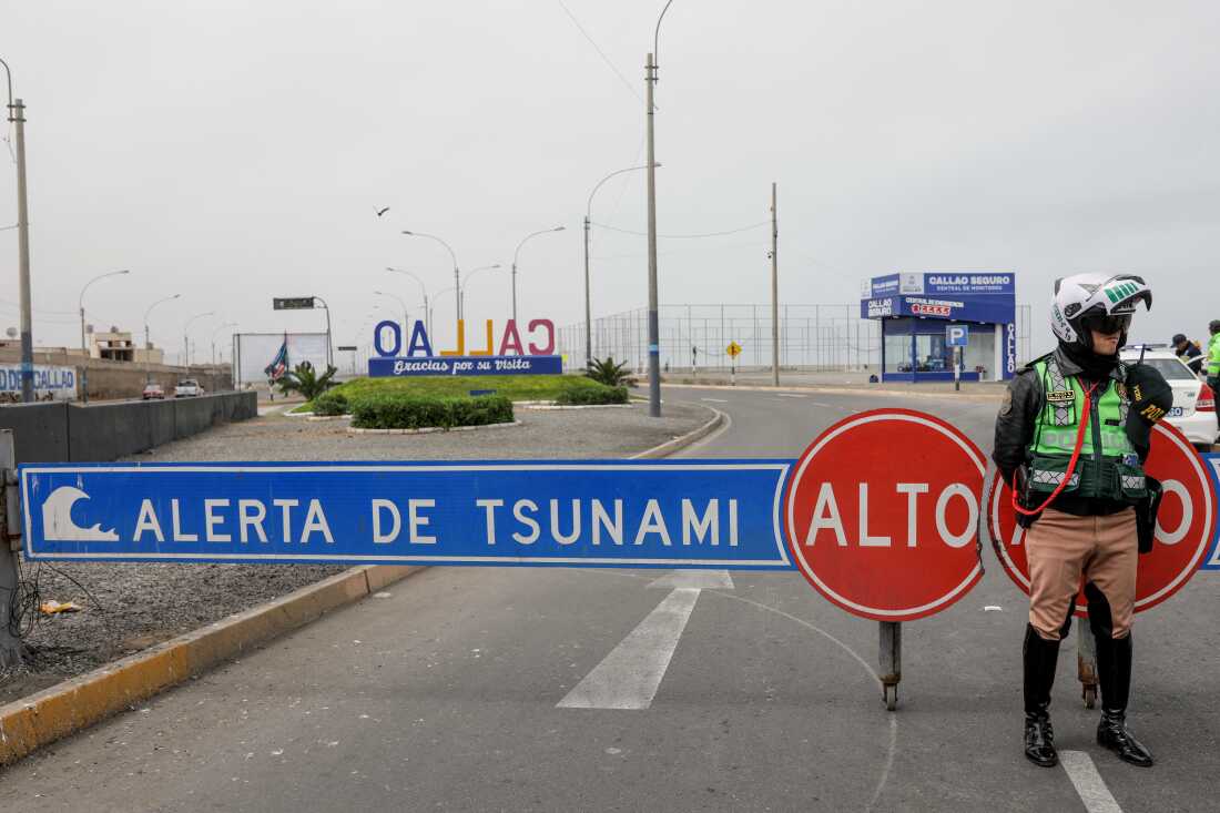 A traffic police officer in Peru sets up a roadblock during a tsunami warning in La Punta, Callao province on July 30, 2025. Alerts were issued in countries across the Pacific, following a massive 8.8-magnitude earthquake off the east coast of Russia.