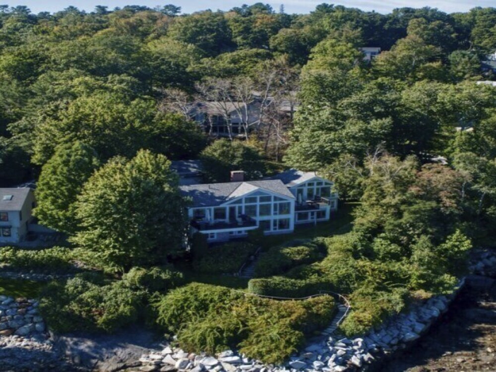 This image provided by Vinal Applebee shows the home of Lisa Gorman in the foreground, the poisoned oak trees behind her home, and the home of the alleged perpetrators behind the dead trees, in Camden, Maine. (AP)