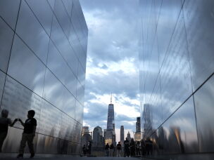 A child walks through the Empty Sky 9/11 Memorial with One World Trade Center and Lower Manhattan in the distance on Aug. 23, 2026 in Jersey City, N.J.
