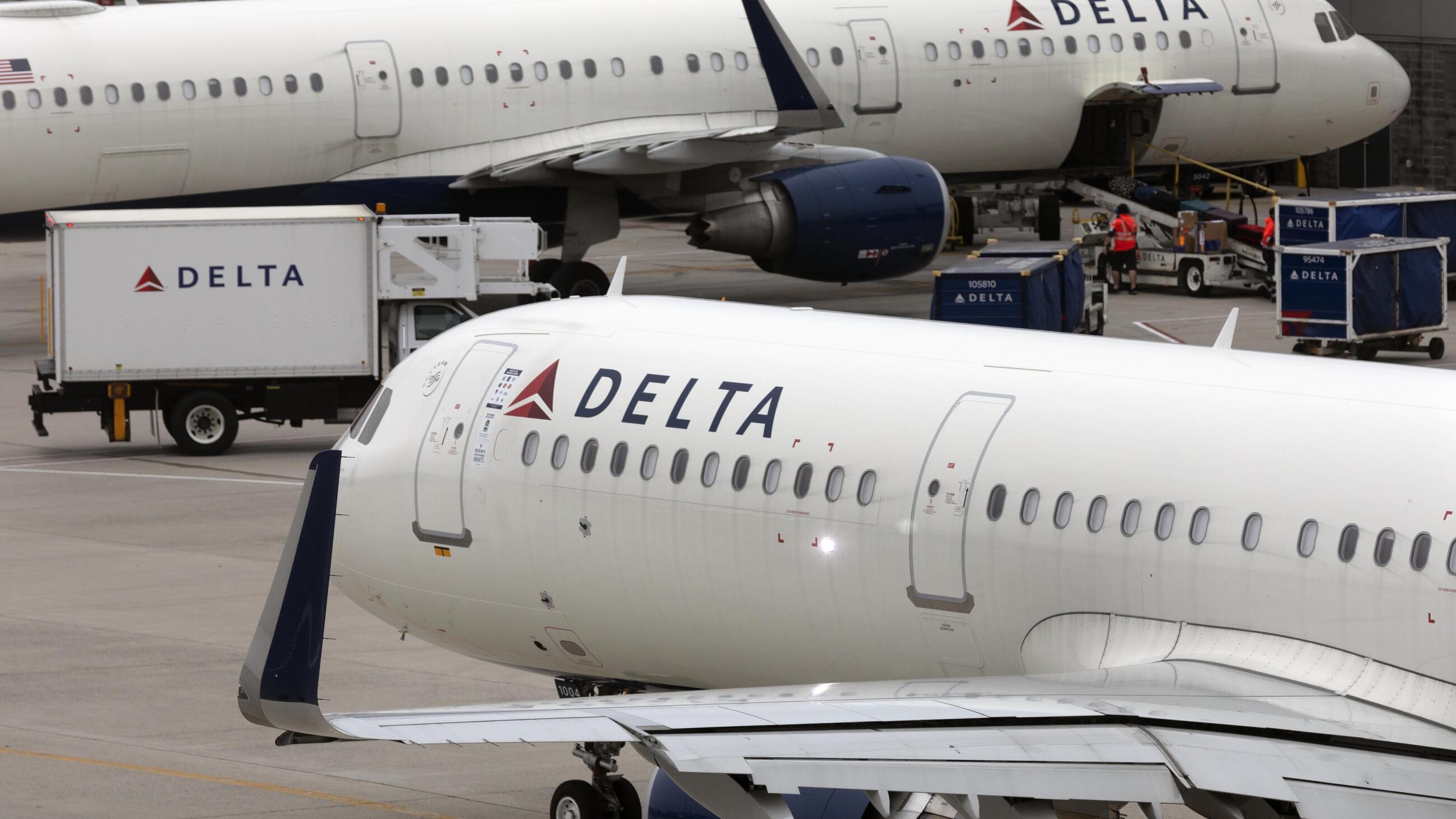 In this photo, a Delta Air Lines plane leaves the gate on July 12, 2021, at Logan International Airport in Boston. The plane is white and bears Delta's name and logo toward the front.