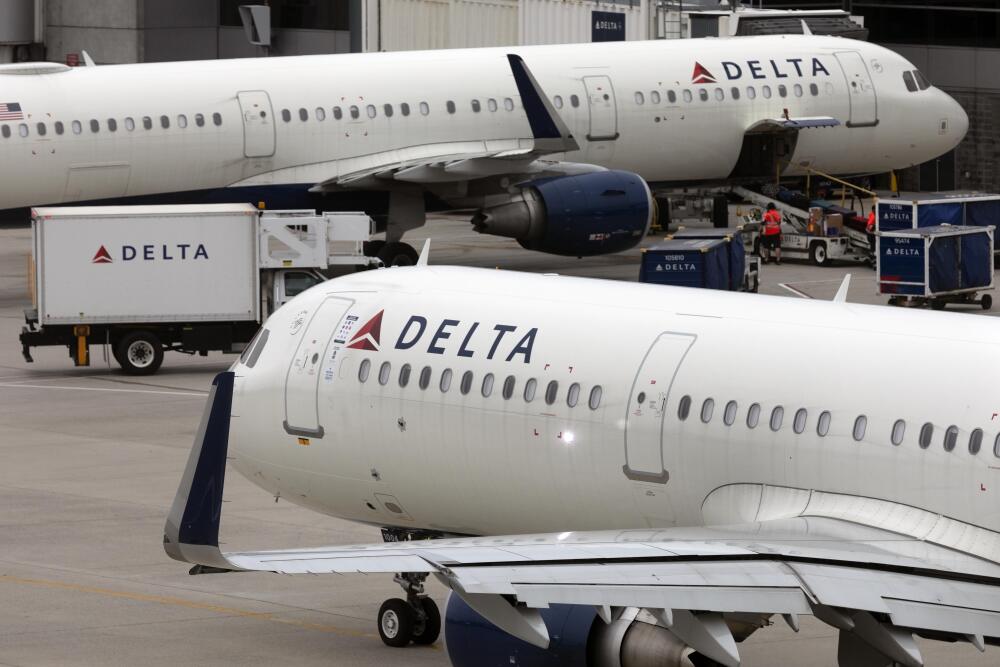 U.S. airline regulators have opened an investigation into Delta Air Lines, which was still struggling to restore operations on Tuesday, more than four full days after a faulty software update caused technological havoc worldwide and disrupted global air travel. Here, a Delta Air Lines plane leaves the gate on July 12, 2021, at Logan International Airport in Boston. (AP)