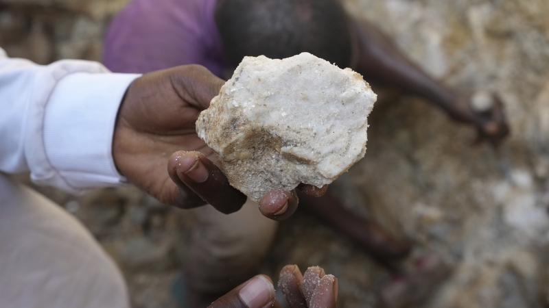A man shows lithium stone from an illegal mining site in Paseli, north central Nigeria, Tuesday, Nov 5, 2024.