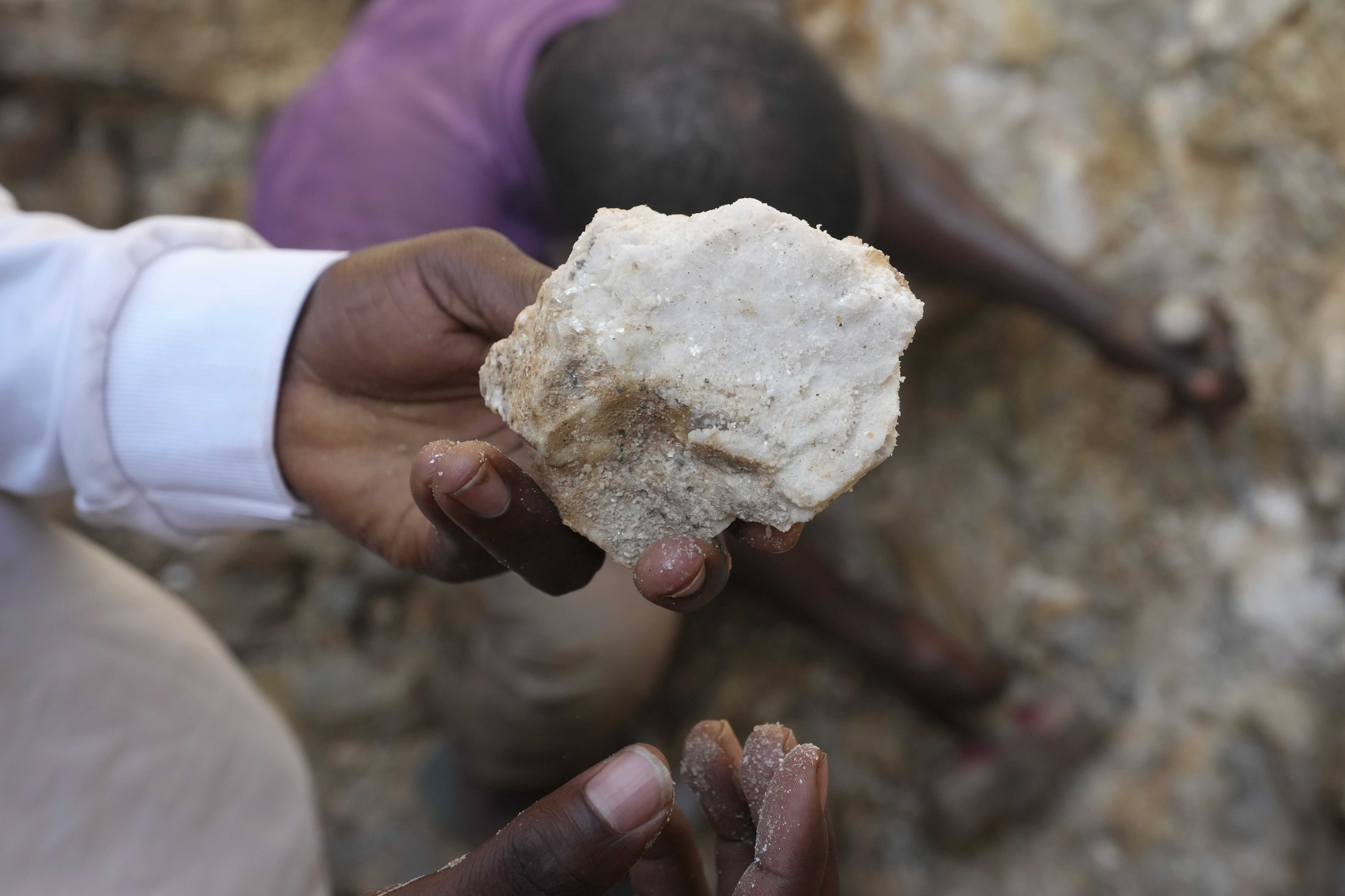 A man shows lithium stone from an illegal mining site in Paseli, north central Nigeria, Tuesday, Nov 5, 2024.